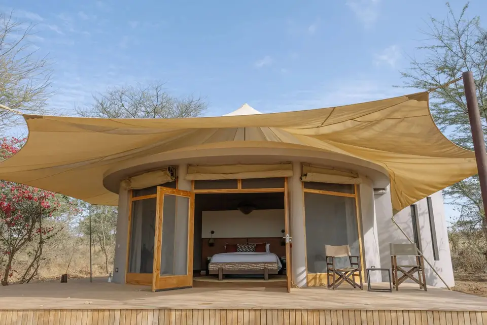 A round banda with a canvas roof and open doors onto its private terrace