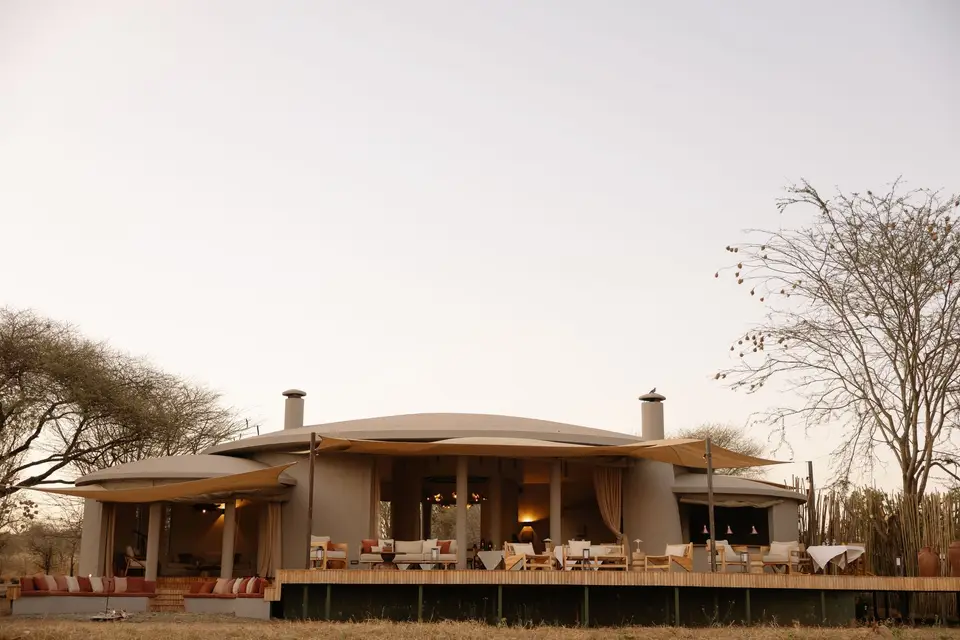 The curved main house of the lodge, open to the plains