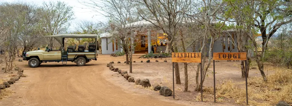 Safari vehicle parked in front of the main lodge at Randilen Plains